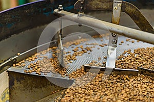 Coffee beans during the roasting process. Drum type roaster. Rosting process of coffee