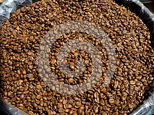 Coffee beans in a sack. Dried coffee sold by the kilo photo