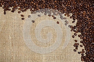 Coffee beans on sacking background