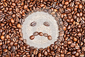 Coffee beans sad smile on burlap