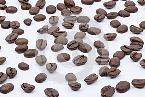 Coffee beans scattered on white background