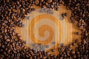 Coffee beans scattered on a wooden table