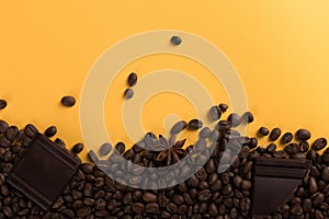 Coffee beans are scattered on a yellow paper background and chocolate, concept, commercial copy space