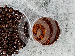 Coffee beans served in saucer with defocused coffee powder