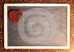 Coffee beans in the shape of heart on a black chalkboard, a lovers flower lovers for Valentine's Day