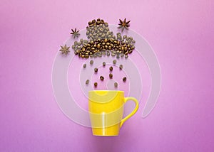 Coffee beans in shape of rainy cloud with yellow mug on purplebackground.