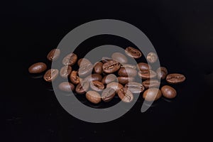 Coffee beans spead on black background