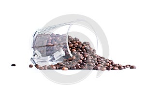 coffee beans spilled from a glass cup isolated on white background