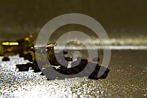 Coffee beans spilled and gold gift boxes on blur background