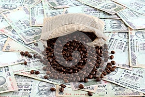 Coffee Beans Spilled on Indian Rupees photo