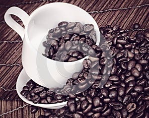Coffee Beans Spilling from a Cup