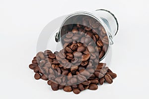 Coffee beans spilling out of bucket