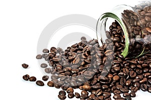 Coffee beans spilling out glass bottle