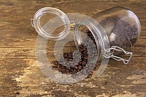 Coffee beans spilling out of a jar