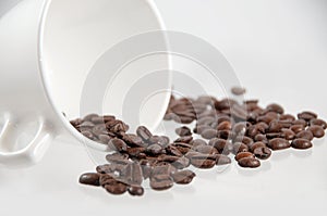 coffee beans spilling out of a mug