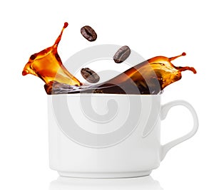 Coffee beans splash in cup of coffee