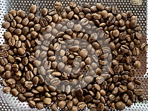 Coffee beans on stainless steel grater