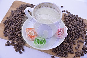 coffee beans and sweets on a white saucer