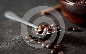 Coffee beans on table. Wooden desk. dark background.