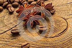 Coffee beans and anise on wooden board