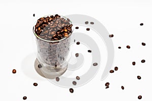 Coffee beans in transparent cup and all around. Background. Texture