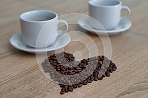 Coffee beans and two cups of coffee, picture of coffee beans for coffe lovers