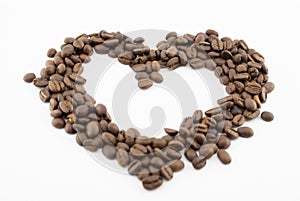 Coffee beans on a white background in the form of a heart isolated