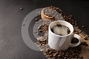 Coffee beans and white cup background