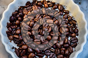 Coffee beans on white dish