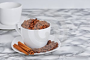 coffee beans in a white mug on a saucer