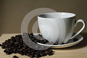 Coffee beans, white coffee mugs placed on wooden