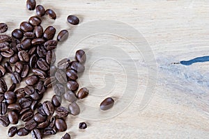 Coffee beans on wooden background, oak wood soft light and beans. Coffee background with wooden texture