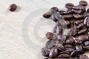 Coffee beans on wooden background, oak wood soft light and beans. Coffee background with wooden texture