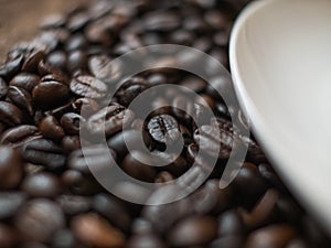 Coffee beans on wooden desk background