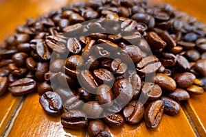 Coffee beans on a wooden desk for the conceptual idea