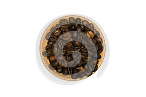 Coffee beans on wooden saucer