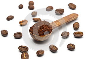 Coffee beans in a wooden scoop isolated on a white background. Roasted coffee beans isolated. A wooden scoop with coffee.