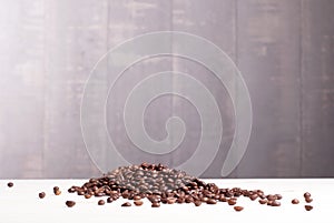 coffee beans on a wooden slide Lightstone table with dark background