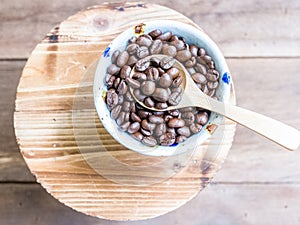 Coffee beans on wooden spoon