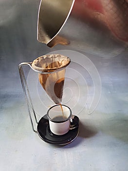 Coffee being brewed in a small coffee percolator