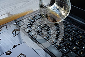 Coffee being spilled over laptop by accident.