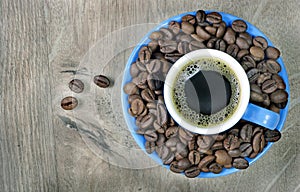 Coffee in a blue cup on a wooden table. top view. copy spaces