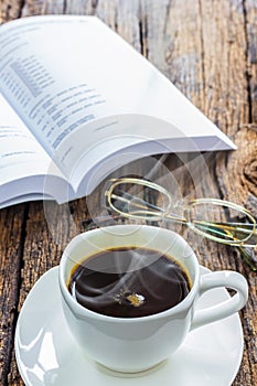 Coffee and book on wood table