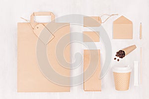 Coffee branding identity mockup - set of brown paper cup, blank bag, packet, label, card, stationery, coffee beans on white wood.