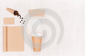 Coffee branding identity mockup - set of brown paper cup, blank notebook, label, card, coffee beans and copy space on white wood.