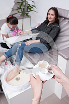 Coffee break in beauty salon during spa procedure