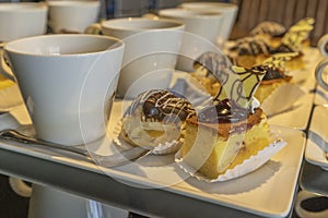 Coffee break cups of hot coffee and cakes on wooden table