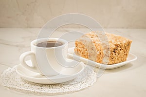 Coffee break with a dessert/coffee cup and dessert on a white marble table. Selective focus