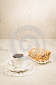 coffee break with a dessert/coffee cup and dessert on a white table
