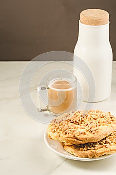 Coffee break with fresh dry biscuit with nuts and bottle milk/ Coffee break with fresh dry biscuit with nuts and bottle milk.